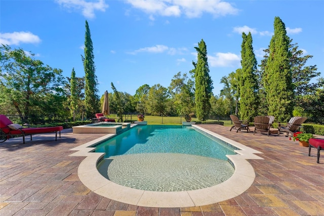 view of swimming pool featuring an in ground hot tub and a patio