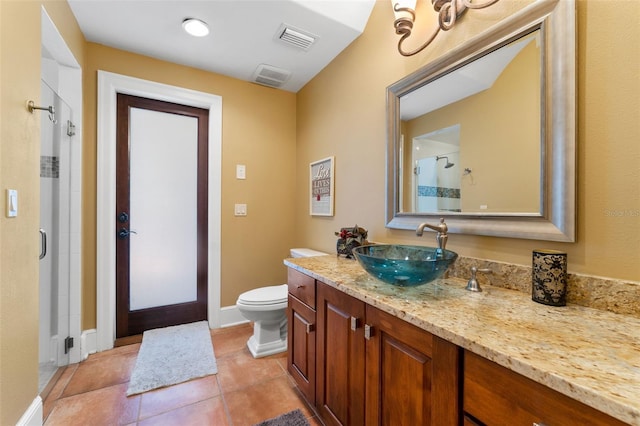 bathroom featuring tile patterned floors, vanity, toilet, and walk in shower