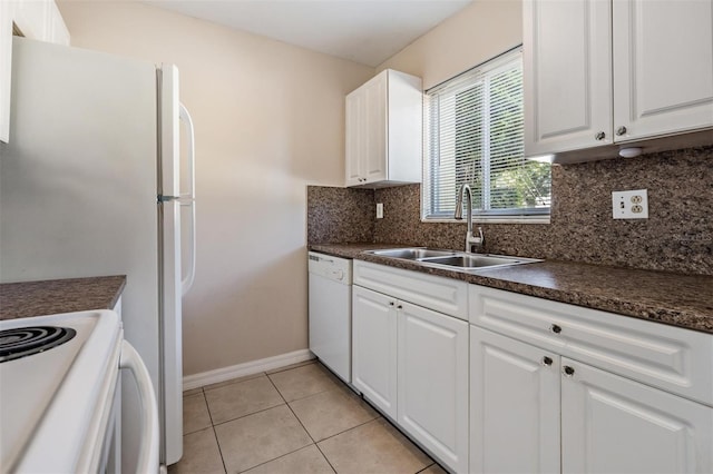 3206 W Azeele St Unit 100, Tampa, FL 33609 - kitchen with white dishwasher, a sink, dark countertops, and white cabinetry