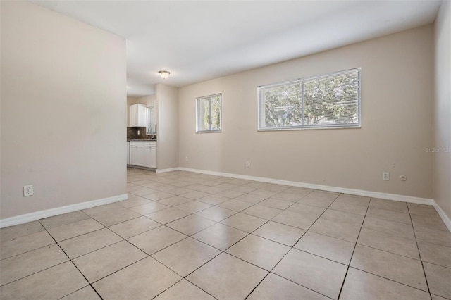 spare room featuring light tile patterned flooring