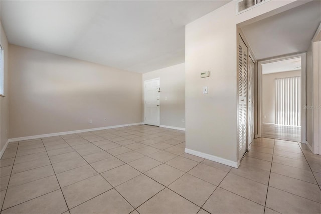 3206 W Azeele St Unit 100, Tampa, FL 33609 - empty room featuring light tile patterned flooring and baseboards