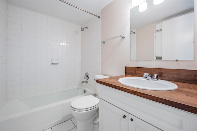 full bathroom featuring tile patterned flooring, vanity, toilet, and tiled shower / bath