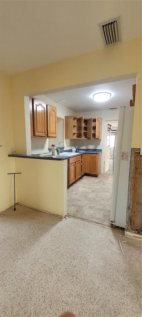 kitchen with sink and white refrigerator