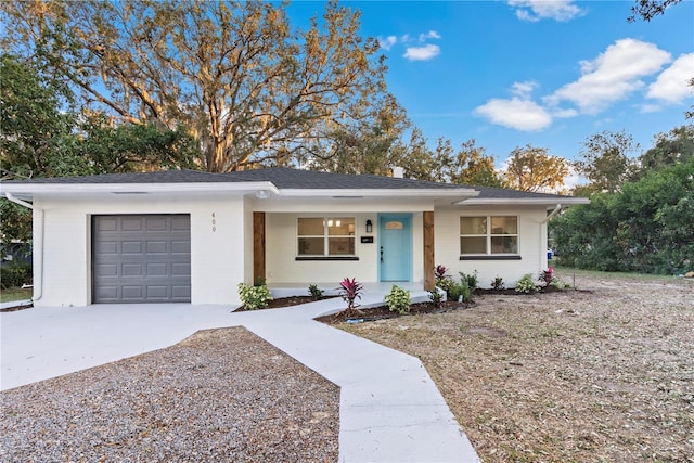 single story home featuring a porch and a garage