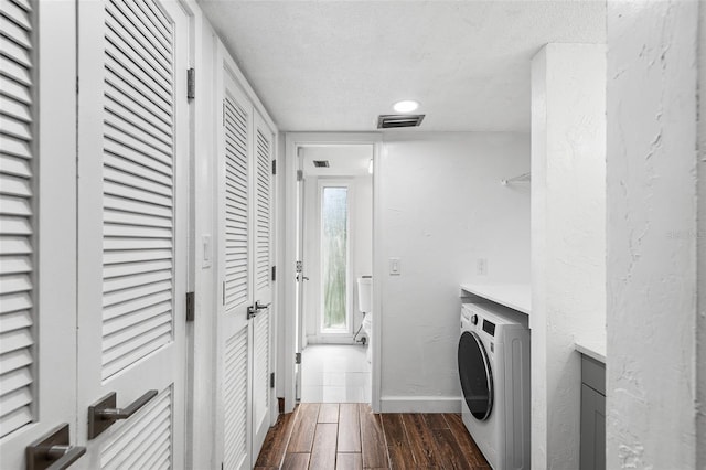 laundry area with washer / clothes dryer, dark hardwood / wood-style flooring, and a textured ceiling