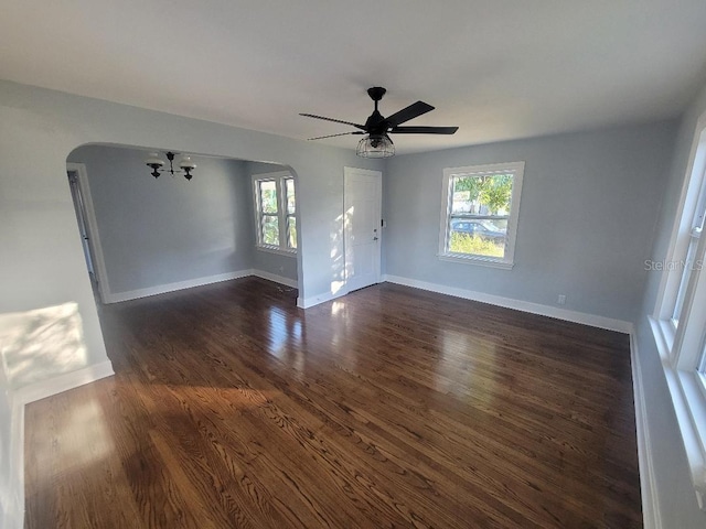 spare room featuring ceiling fan and dark hardwood / wood-style flooring