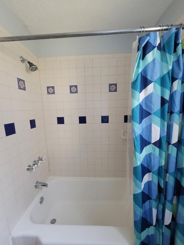 bathroom featuring shower / bath combo with shower curtain