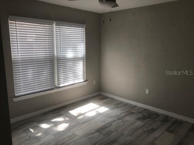 unfurnished room featuring hardwood / wood-style floors and ceiling fan