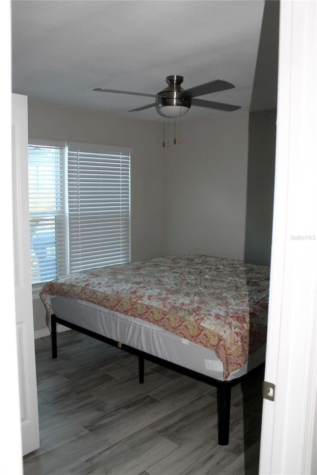 bedroom featuring ceiling fan and wood-type flooring