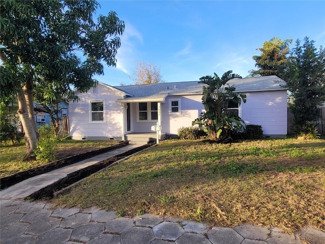 ranch-style home with a front lawn