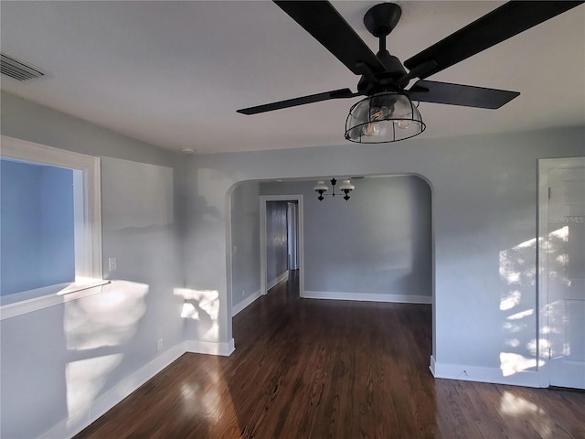 unfurnished room with dark hardwood / wood-style floors and ceiling fan