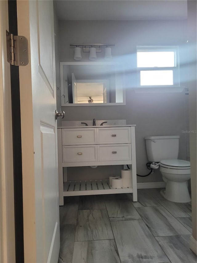 bathroom featuring vanity and toilet