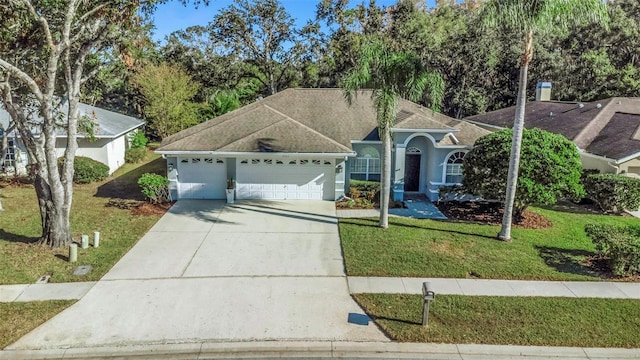 ranch-style home featuring a garage and a front lawn