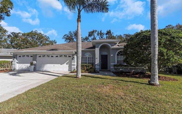 view of front of home with a front yard and a garage