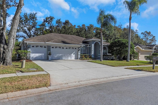 ranch-style house featuring a garage and a front yard