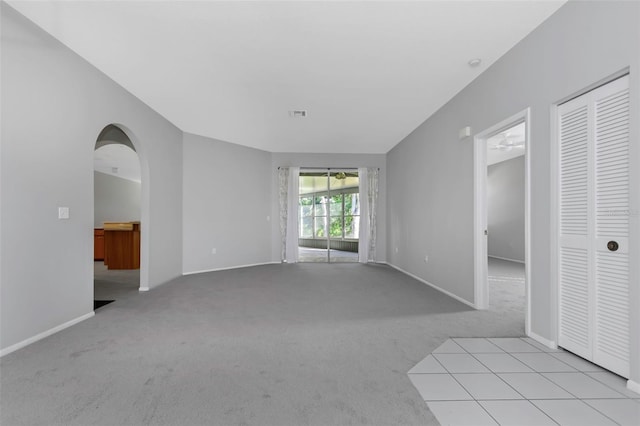 spare room with ceiling fan and light colored carpet