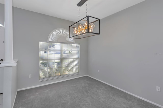 unfurnished dining area with dark colored carpet and an inviting chandelier