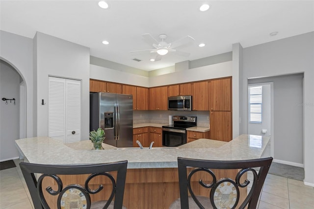 kitchen with ceiling fan, light tile patterned floors, sink, and appliances with stainless steel finishes