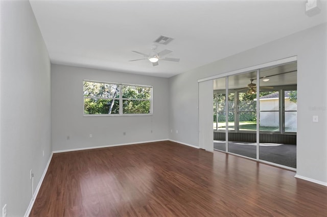 empty room featuring dark hardwood / wood-style floors and ceiling fan