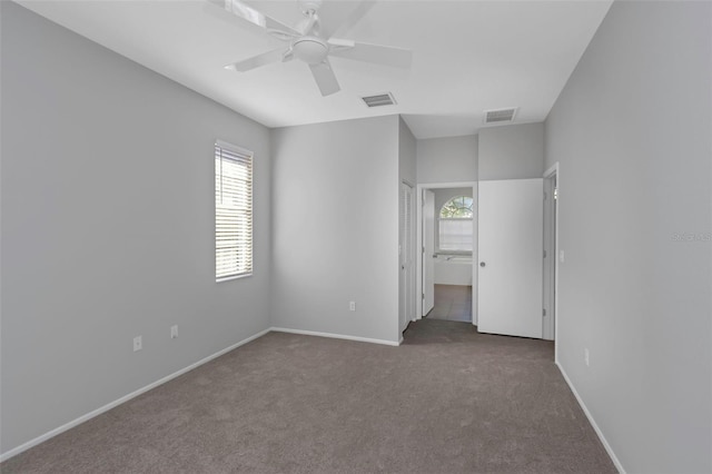 spare room featuring carpet floors and ceiling fan