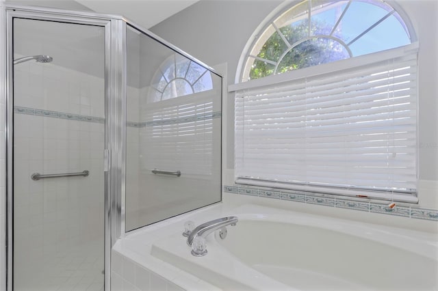 bathroom featuring shower with separate bathtub