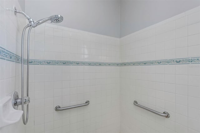 bathroom with tiled shower