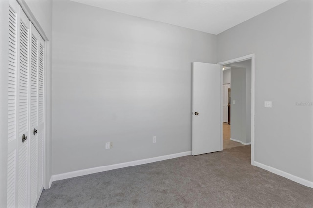 unfurnished bedroom with light carpet and a closet