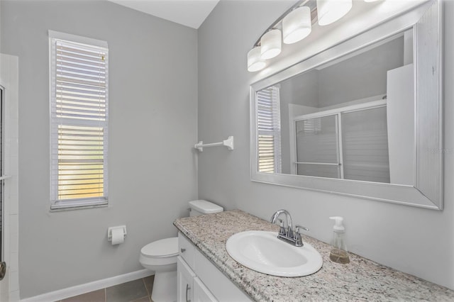 bathroom with toilet, vanity, tile patterned floors, and a shower with door