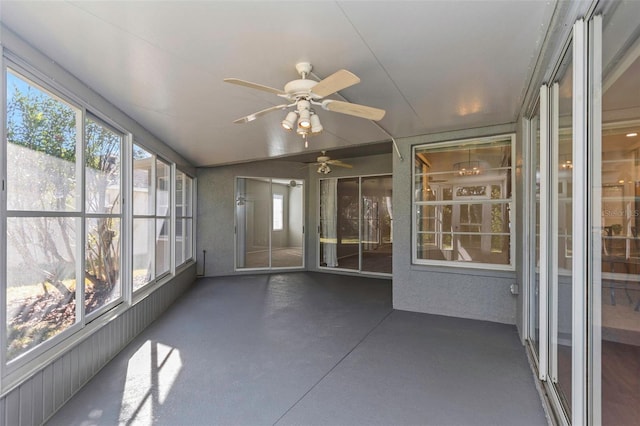 unfurnished sunroom featuring plenty of natural light, lofted ceiling, and ceiling fan