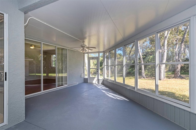 unfurnished sunroom featuring ceiling fan