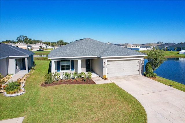 single story home with a water view, a garage, and a front lawn