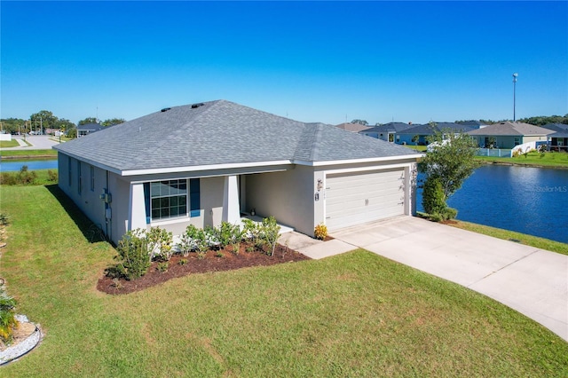 ranch-style house with a water view, a front yard, and a garage