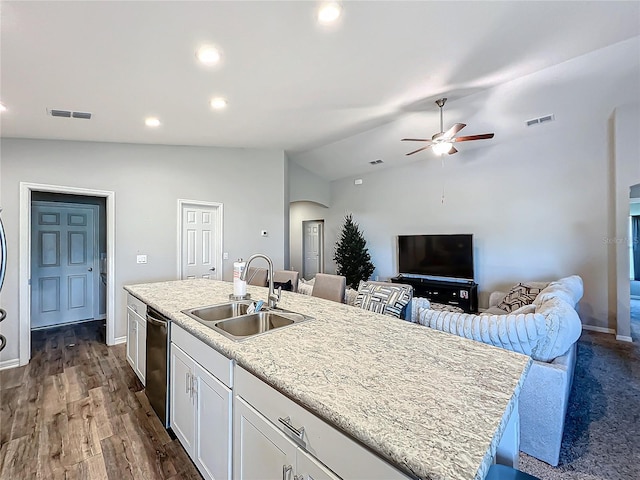 kitchen with white cabinetry, sink, dark hardwood / wood-style flooring, an island with sink, and lofted ceiling