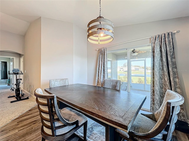 dining area featuring ceiling fan, wood-type flooring, and lofted ceiling