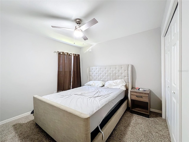 carpeted bedroom featuring a closet and ceiling fan