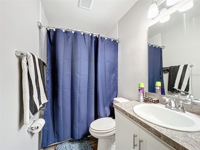 bathroom featuring hardwood / wood-style floors, vanity, toilet, and a shower with shower curtain