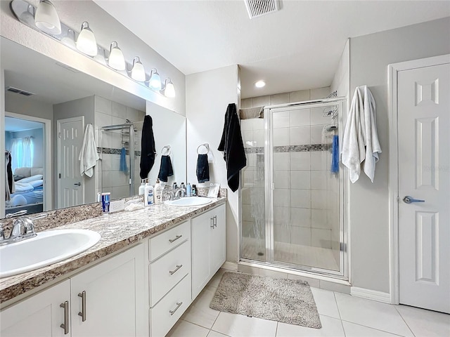 bathroom featuring vanity, tile patterned floors, and a shower with shower door