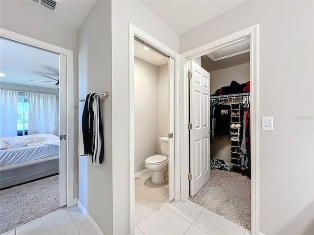 bathroom with tile patterned floors, ceiling fan, and toilet