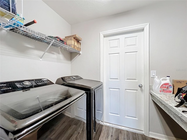 washroom featuring dark wood-type flooring and washer and dryer