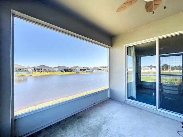 exterior space featuring a water view, a wealth of natural light, and ceiling fan