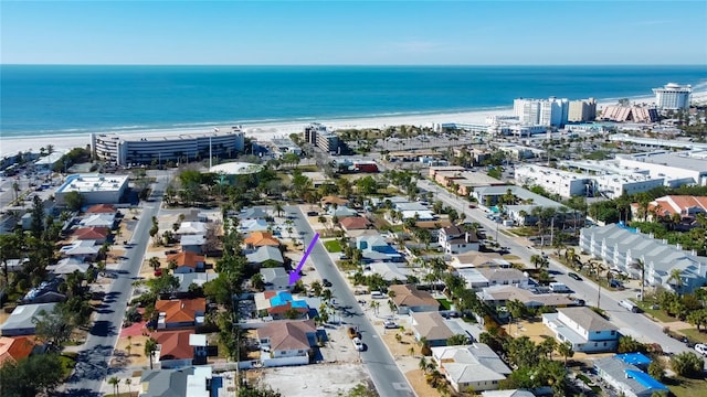 drone / aerial view featuring a water view and a view of the beach