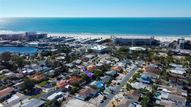 birds eye view of property featuring a water view and a beach view