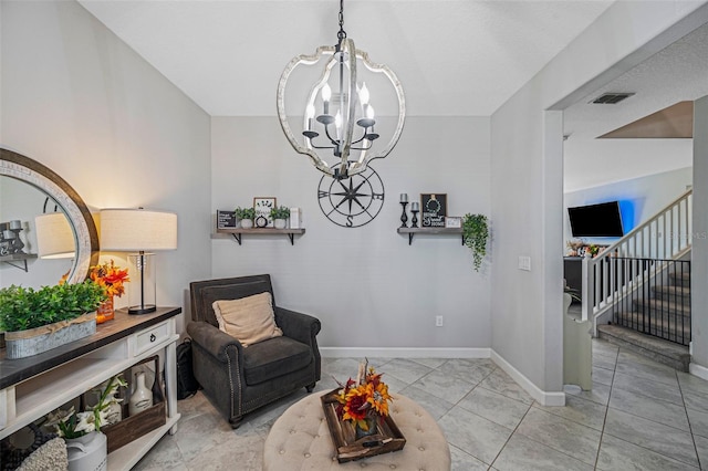 sitting room featuring light tile patterned floors and a notable chandelier