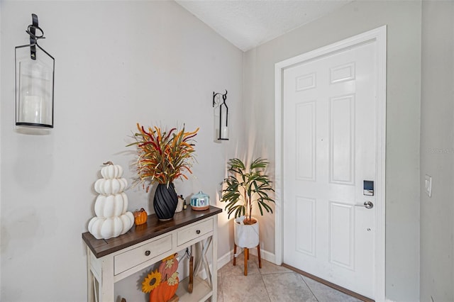 11321 Chilly Water Ct, Riverview, FL 33569 - foyer entrance with light tile patterned floors, baseboards, and a textured ceiling