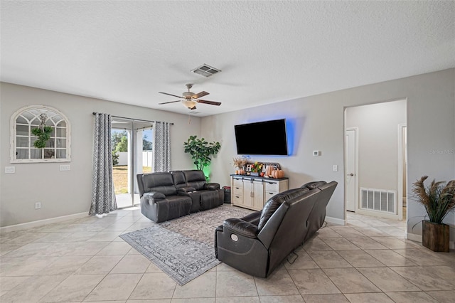 11321 Chilly Water Ct, Riverview, FL 33569 - living area featuring a ceiling fan, a textured ceiling, light tile patterned floors, and baseboards