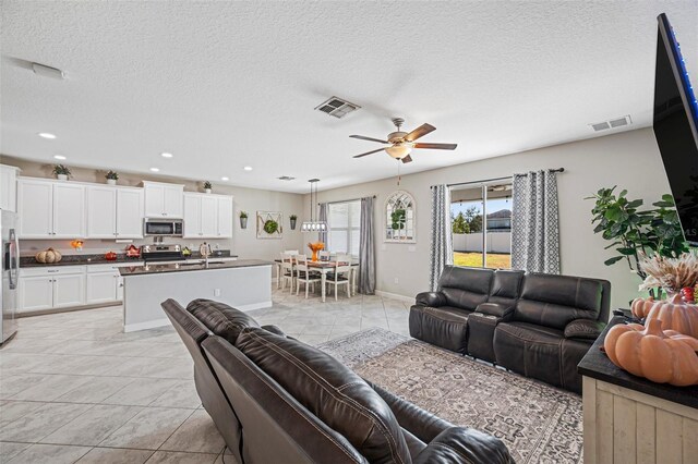 11321 Chilly Water Ct, Riverview, FL 33569 - living room with ceiling fan, baseboards, a textured ceiling, and recessed lighting