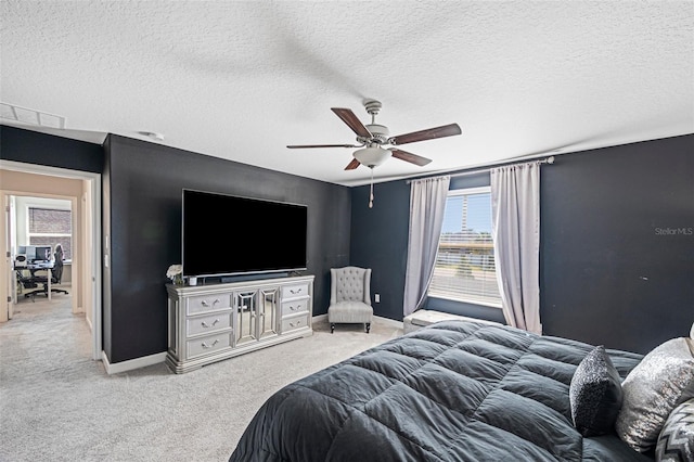 bedroom featuring ceiling fan, carpet floors, and a textured ceiling