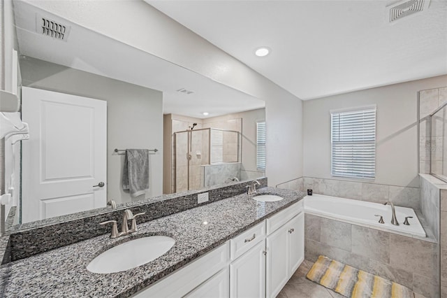 bathroom featuring tile patterned flooring, vanity, and separate shower and tub