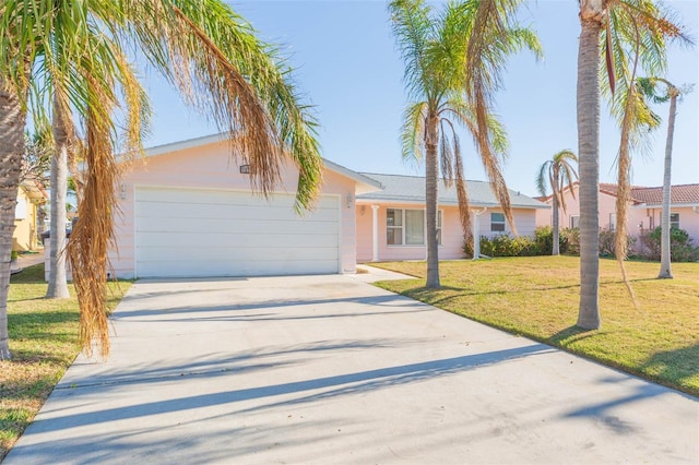 single story home with a garage and a front lawn