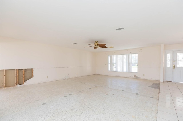 unfurnished room featuring plenty of natural light and ceiling fan